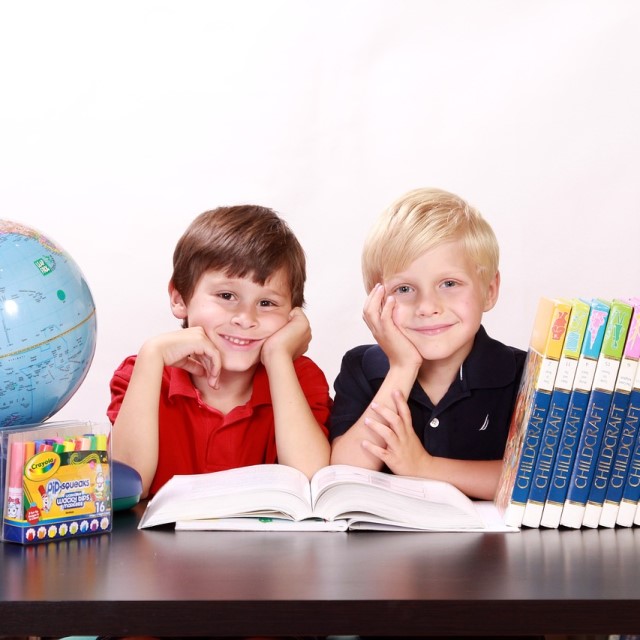 Helping Kids Transition Back into the School Year - Two Boys Sitting Reading Textbook
