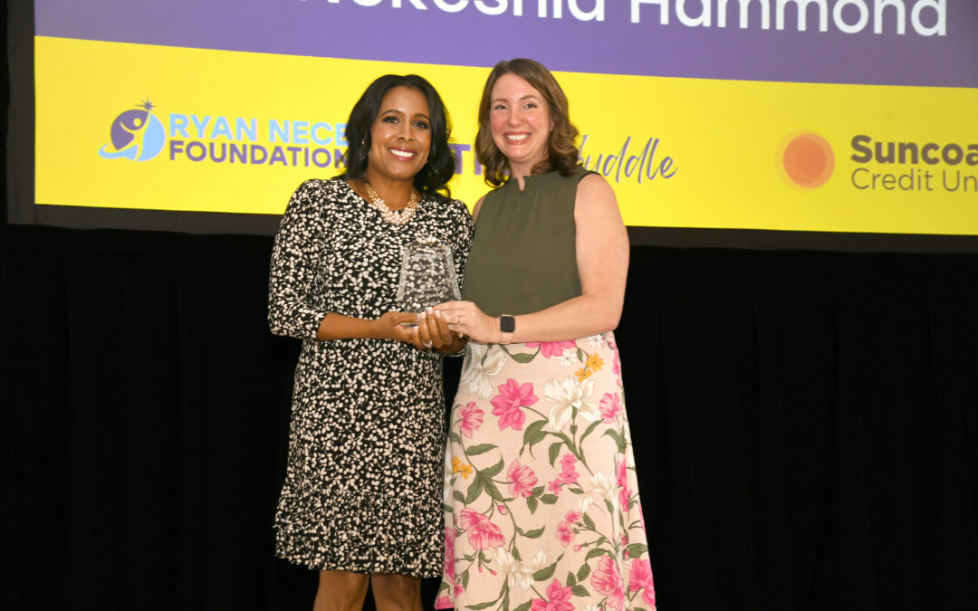 Dr. Nekeshia Hammond receiving the Paragon Award from the CEO of the Ryan Nece Foundation at the 2025 Huddle Luncheon