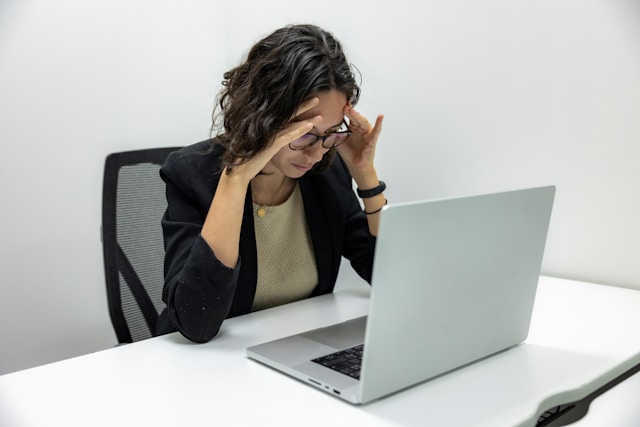 Adult sitting at desk looking overwhelmed, representing ADHD symptoms and the need for professional testing