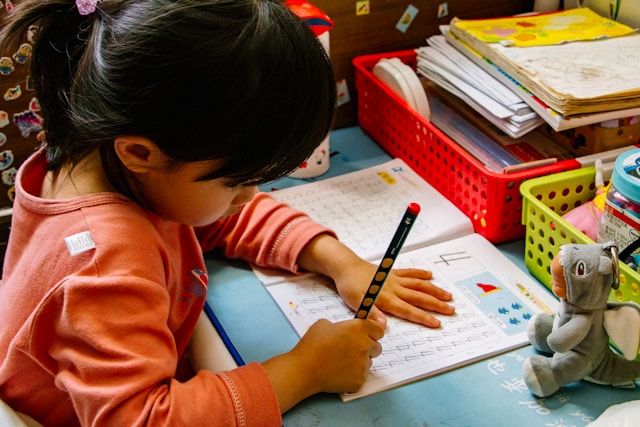 Young girl writing at school, showing signs of giftedness