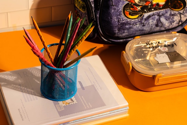 Desk with pencils in a cup and stacked books, symbolizing school accommodations and IEP or 504 planning.