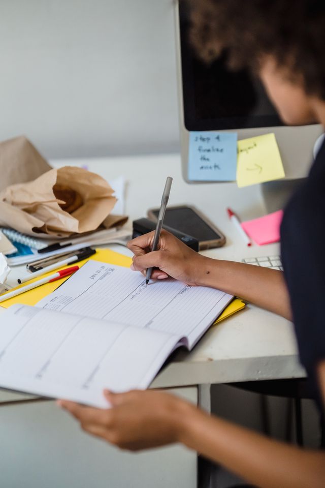 Teenager using a planner and checklist to organize tasks, illustrating executive functioning skills such as planning and time management.