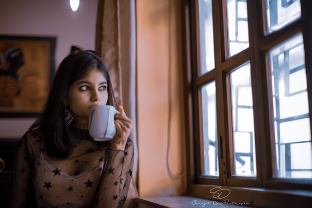 Person sitting by a window reflecting on feelings of worry and anxiety, illustrating when everyday worry may become an anxiety disorder.