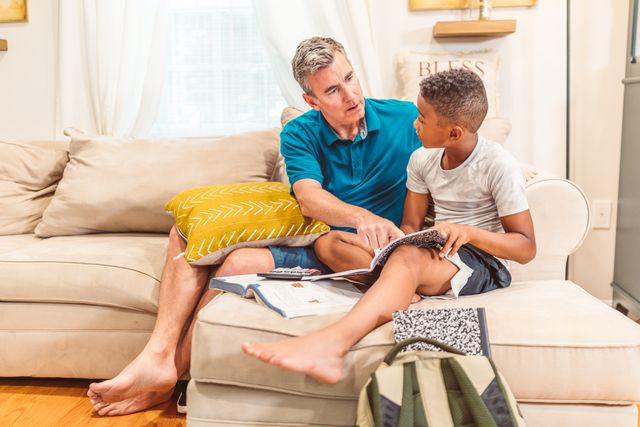Father helping son with homework at home