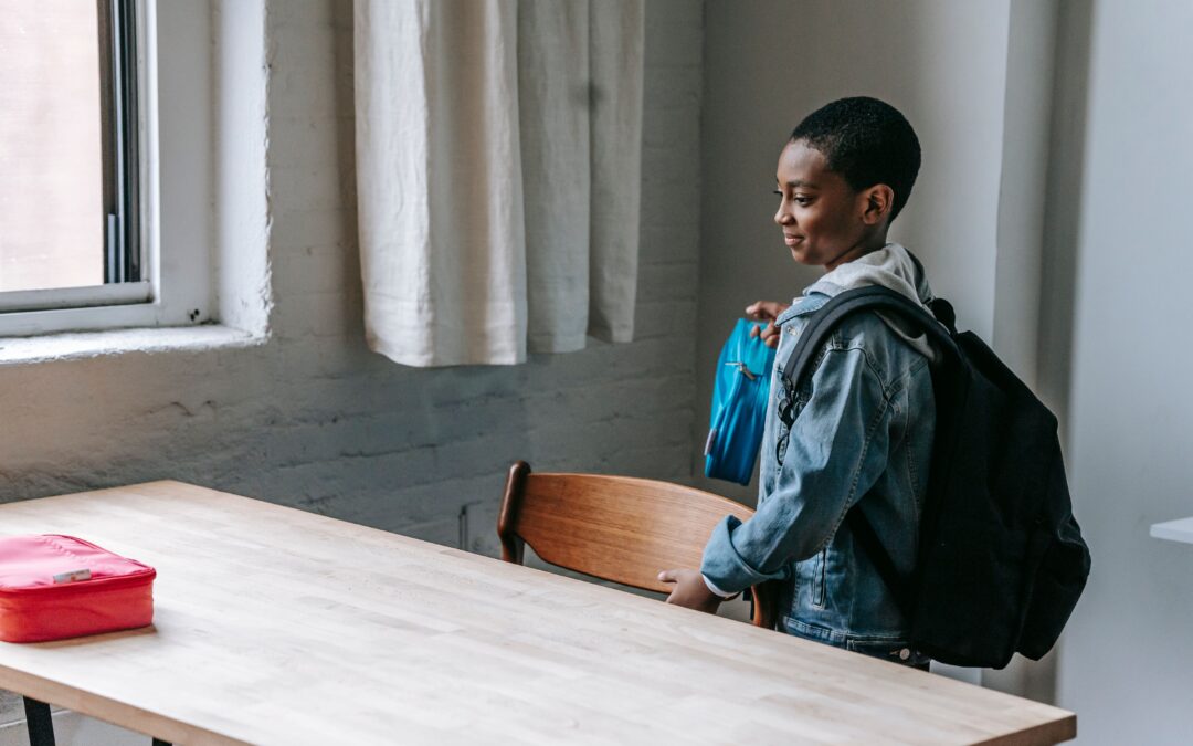 Child with backpack experiencing back-to-school anxiety