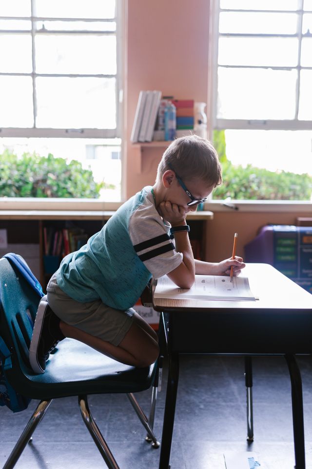 Child in classroom working on schoolwork