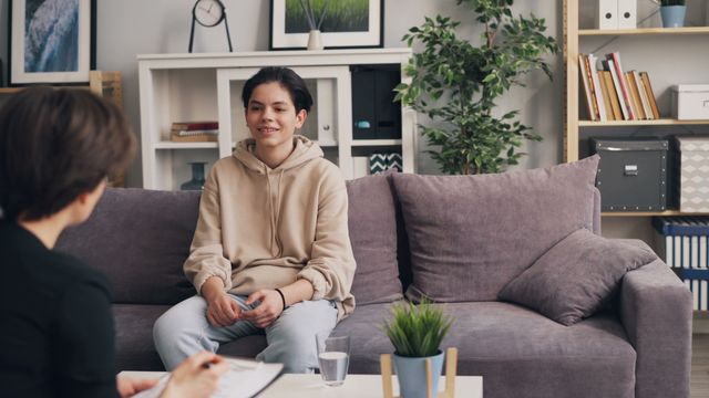 Teen boy talking with a psychologist during a psychological evaluation