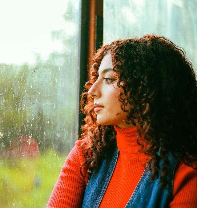 Woman looking thoughtfully out of a window
