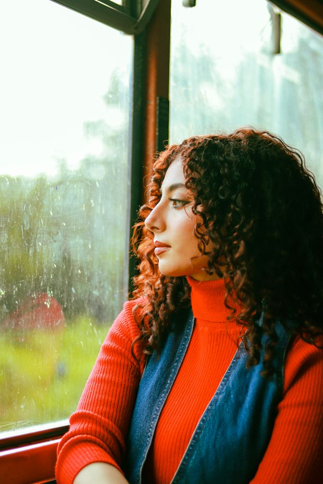 Woman looking thoughtfully out of a window